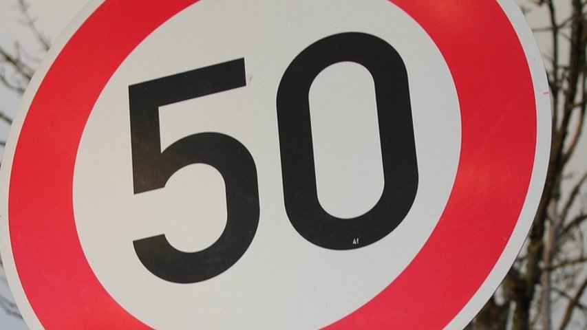 Ein "Tempo 50"-Schild über einem Parkverbot-Schild. 