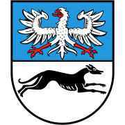 Wappen von Battenberg. Obere Hälfte hellblau mit weißem Adler. Untere Hälfte weiß mit schwarzem Jagdhund. 