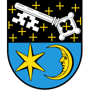 Wappen von Laumersheim. Horizontal halbiert, oben ein weißer Schlüssel auf Schwarz, umgeben von gelben Kreuzen. Unten ein Stern und ein Halbmond auf Hellblau. 