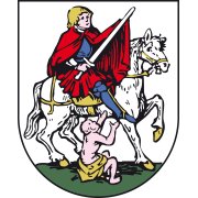 Wappen von Gönnheim. Weißer Hintergrund. Der heilige Martin reitet in blauem Harnisch auf einem Schimmel und teilt seinen roten Mantel mit einem silbernen Schwert. Am grünen Boden sitzt der Bettler. 